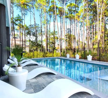 Driftwood-4 Avoid the hassle of competing for poolside chairs at a community pool. Driftwood boasts a fully fenced backyard featuring a private (seasonally heated) pool with a splash deck, ensuring your comfort and leisure.