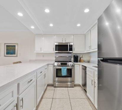 Well stocked kitchen with new stainless steel appliances.