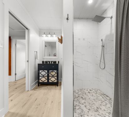 Hall bath next to 2 bedrooms offers fully tiled, spacious shower stall