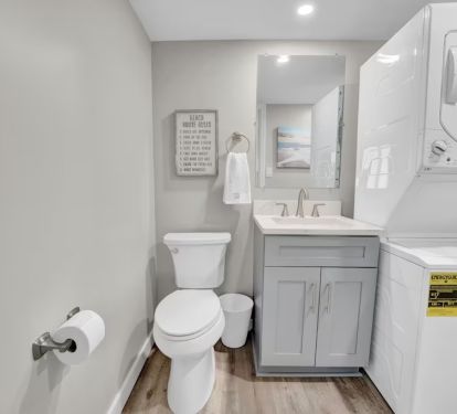 1/2 Bath and stacked washer /Dryer off Kitchen.