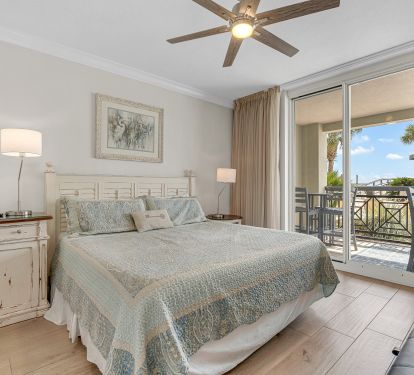 Primary king suite with patio access and Gulf views.
