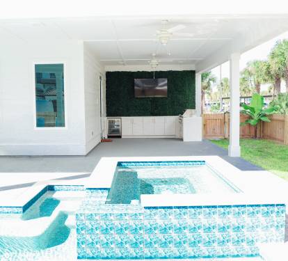Hot tub and pool area with grill and TV