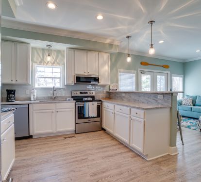 Kitchen with new solid counter tops and all new appliances. Bar seating for 4.