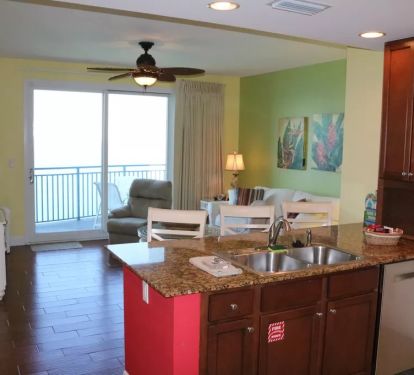 Kitchen, living area, and balcony overlooking ocean