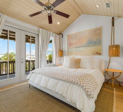 Wake up to vaulted ceilings, Gulf light, and your own balcony in the top-floor Primary King Suite