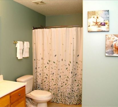 Both bathrooms are roomy and offer curved hotel shower rods.