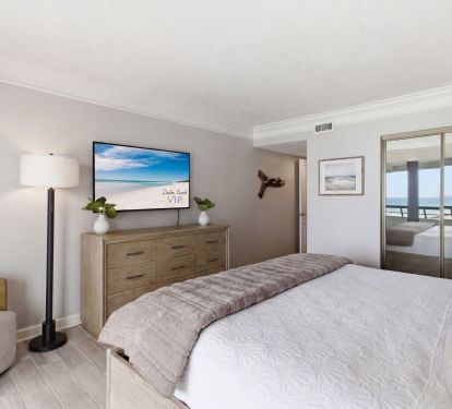 Primary bedroom with large smart TV