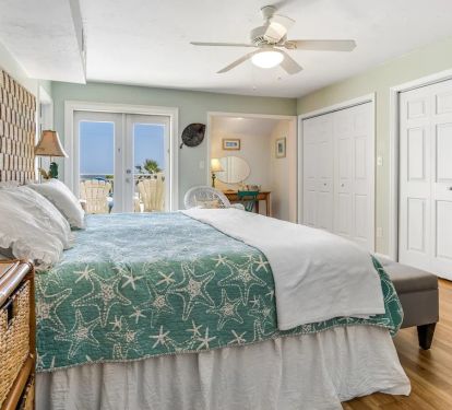 Upper main king bedroom with private balcony, vanity area and large closets