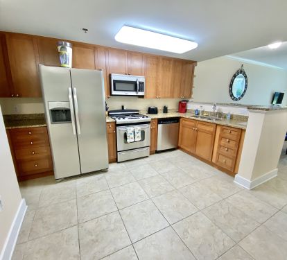 Large kitchen with lots of storage and stocked with essentials for cooking. 