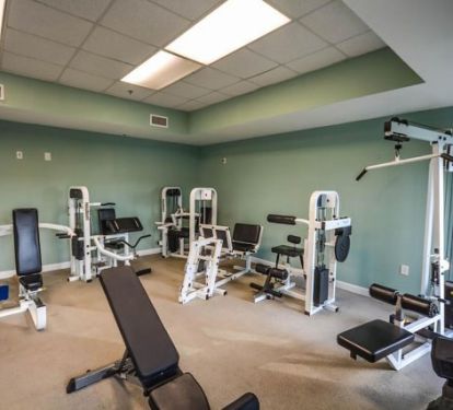 On-site fitness center with weight machines and strength training equipment