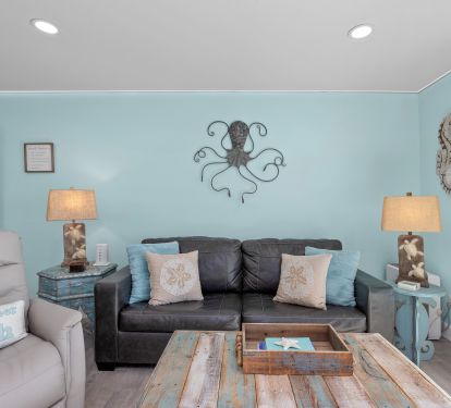Living area offers a leather sofa sleeper; recliner; 65 inch TV &amp; PS5