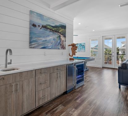 Full wet bar next to pool table and lounge area