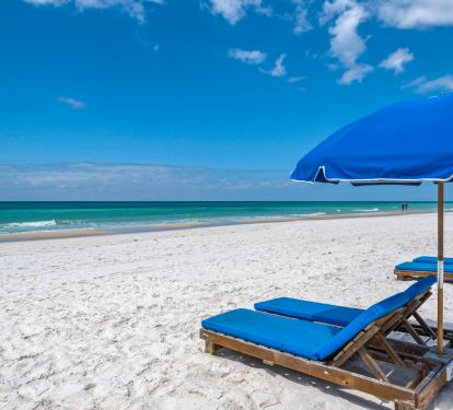 Set of  seasonal beach chairs with umbrella service is included with this condo