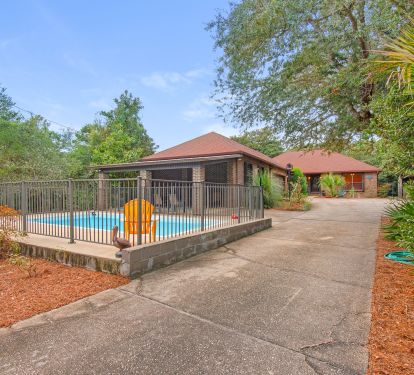 Pool with covered patio for grilling and enjoying family outdoors