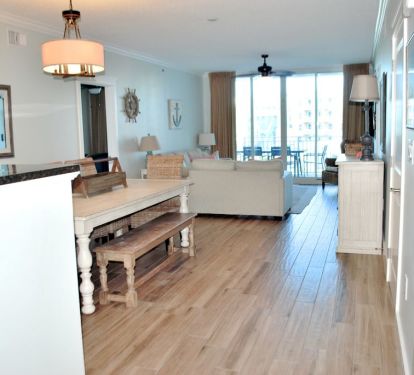 view from entryway. Newly installed wood look tile throughout living and dining