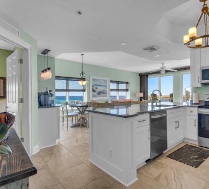 View leading into kitchen, middle bedroom (on left), dining &amp; living areas.