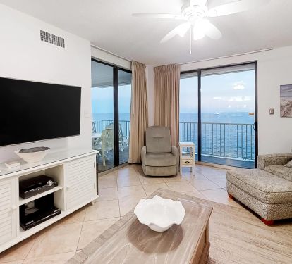Living room with view of beach and water