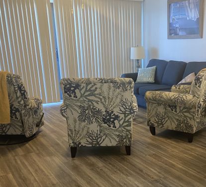 The living area offers ample seating including a recliner. 