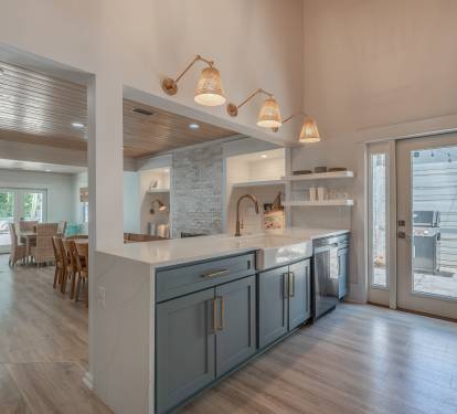 Open floor plan and fully stocked kitchen with easy access to brand new grill.