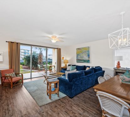 Beautiful living room with floor to ceiling windows, step right out to the pool.