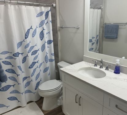 Boys' bath has tub/shower, two lavatories, &amp; plenty of towel rods.
