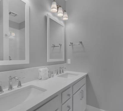 Both private ensuites feature luxurious quartz countertops and dual vanities.