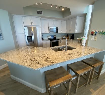 Custom white shaker kitchen with white ice granite counters.