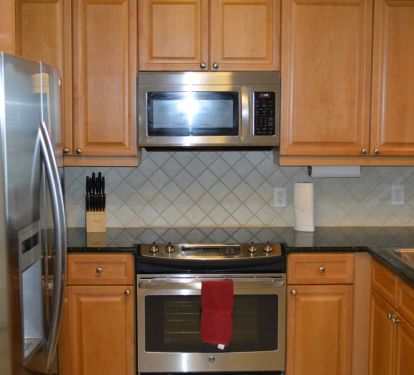 Modern, fully outfitted kitchen, with marble counter tops