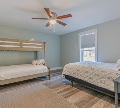 Main floor bedroom with queen bed and twin over full bunk(second picture) 
