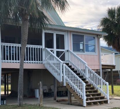 Enjoy watching sunsets from the screen room or from the hot tub under the house.