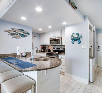 Eat at the kitchen breakfast bar or the 2 person table