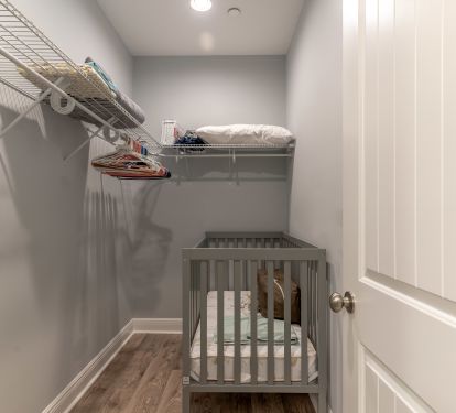 Walk in closet with full sized crib and pack and play