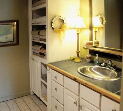 Sink area and linen storage in the bathroom