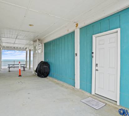 Deck with outdoor shower and picnic table on the water
