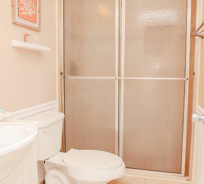The queen bedroom offers a private bathroom with a tiled, walk-in shower.