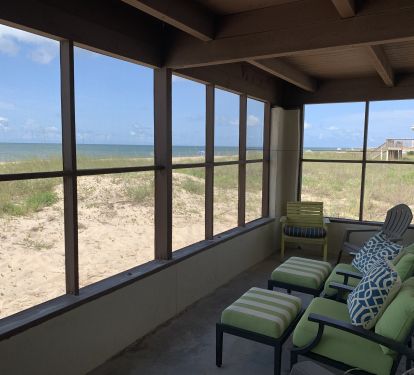 Screened in porch with comfortable seating