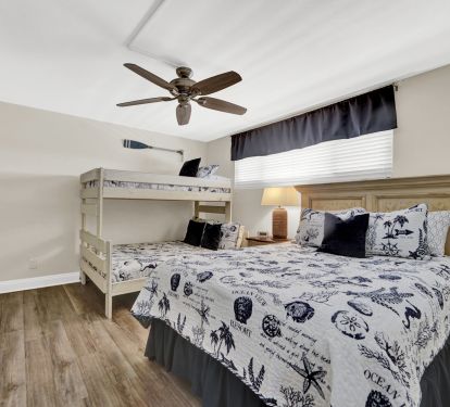 Guest room which includes a queen and twin over full bunk bed.