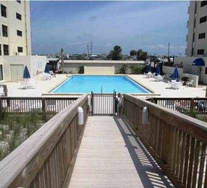 Large pool with lounge furniture and bathrooms