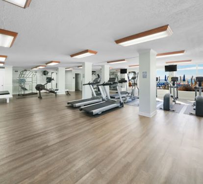 Workout Room looking out at the pool / beautiful beach.