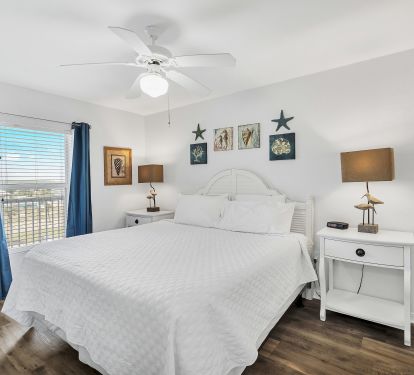 Master Bedroom with King Bed and twin bedside tables and TV.