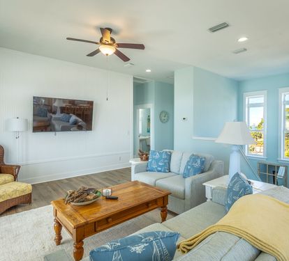 Living room w/ new 65 inch TV...and all new big screen TV's in every BR