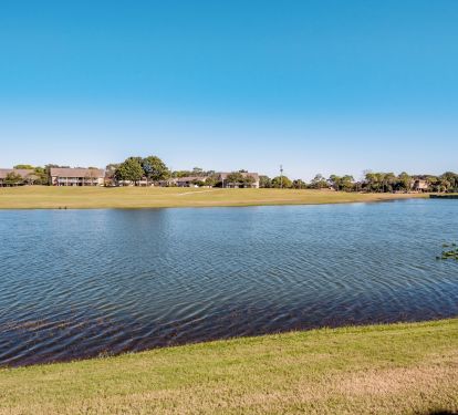 View from patio. 14th hole of golf course plays on the other side of the lake.