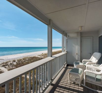 View of ocean and beach from balcony (to the west) with two rocking chairs