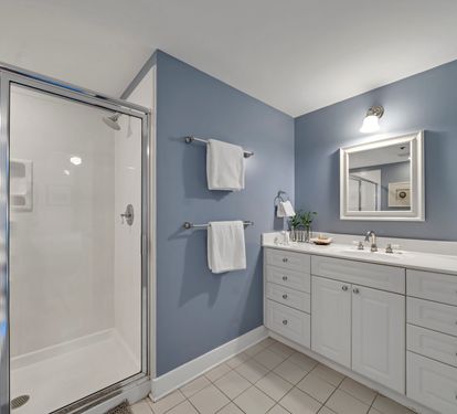 Second bedroom bath with single vanity and walk-in shower. Also includes a soaking tub