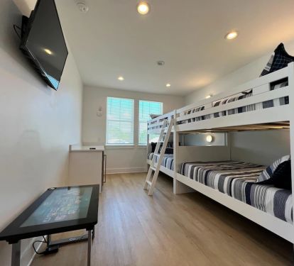Bunk room with 4 full beds and individual coastal lights in each bunk for either a nightlight or reading!