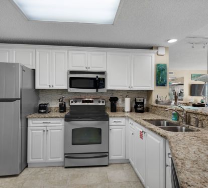 Fully equipped kitchen with stainless steel appliances.