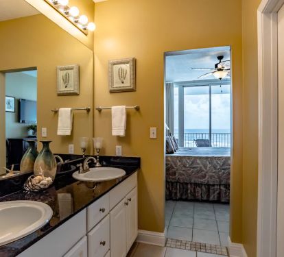 Master bathroom with separate sink area and walk in closet