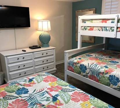 Guest bedroom offering 2 twin and 1 full size beds