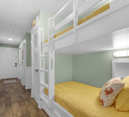 Twin bunks in cozy nook with lights and outlets for phone