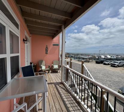 Balcony with patio furniture overlooking the water and marina